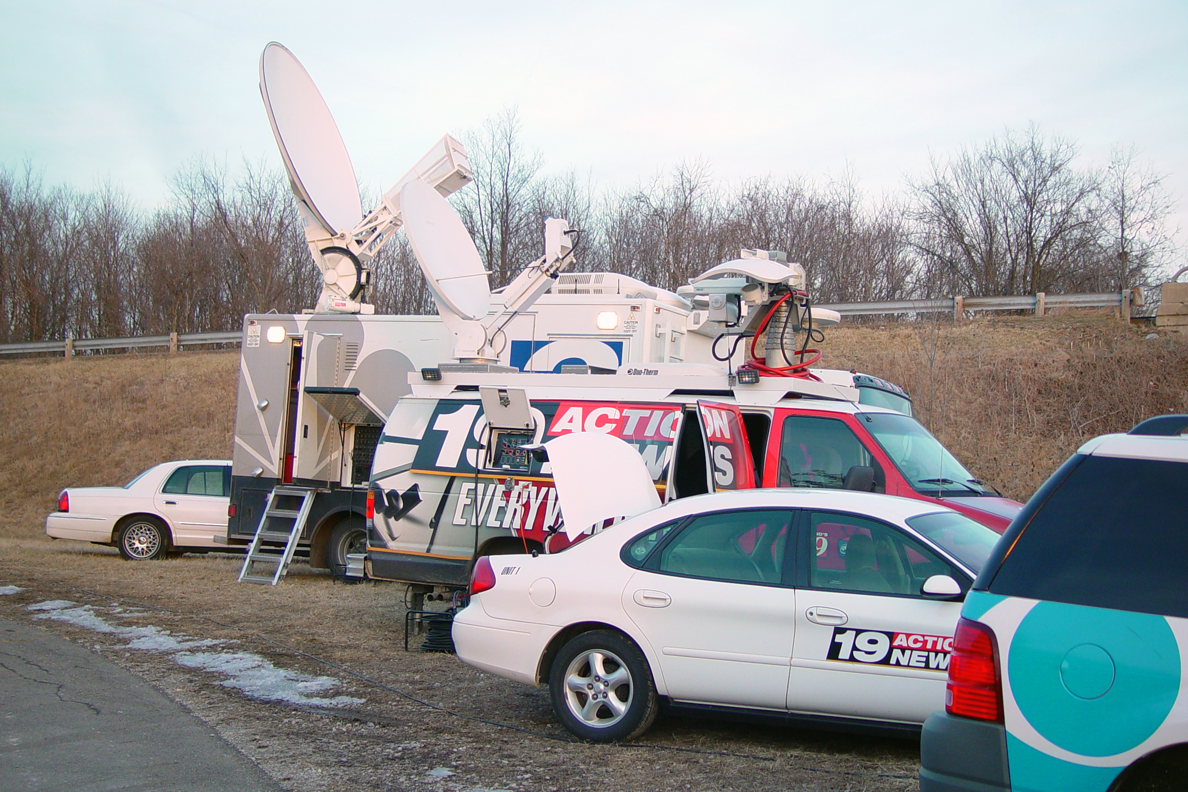 photo of news trucks with satellite feeds