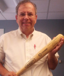 Russ Poulin holding a baseball bat.
