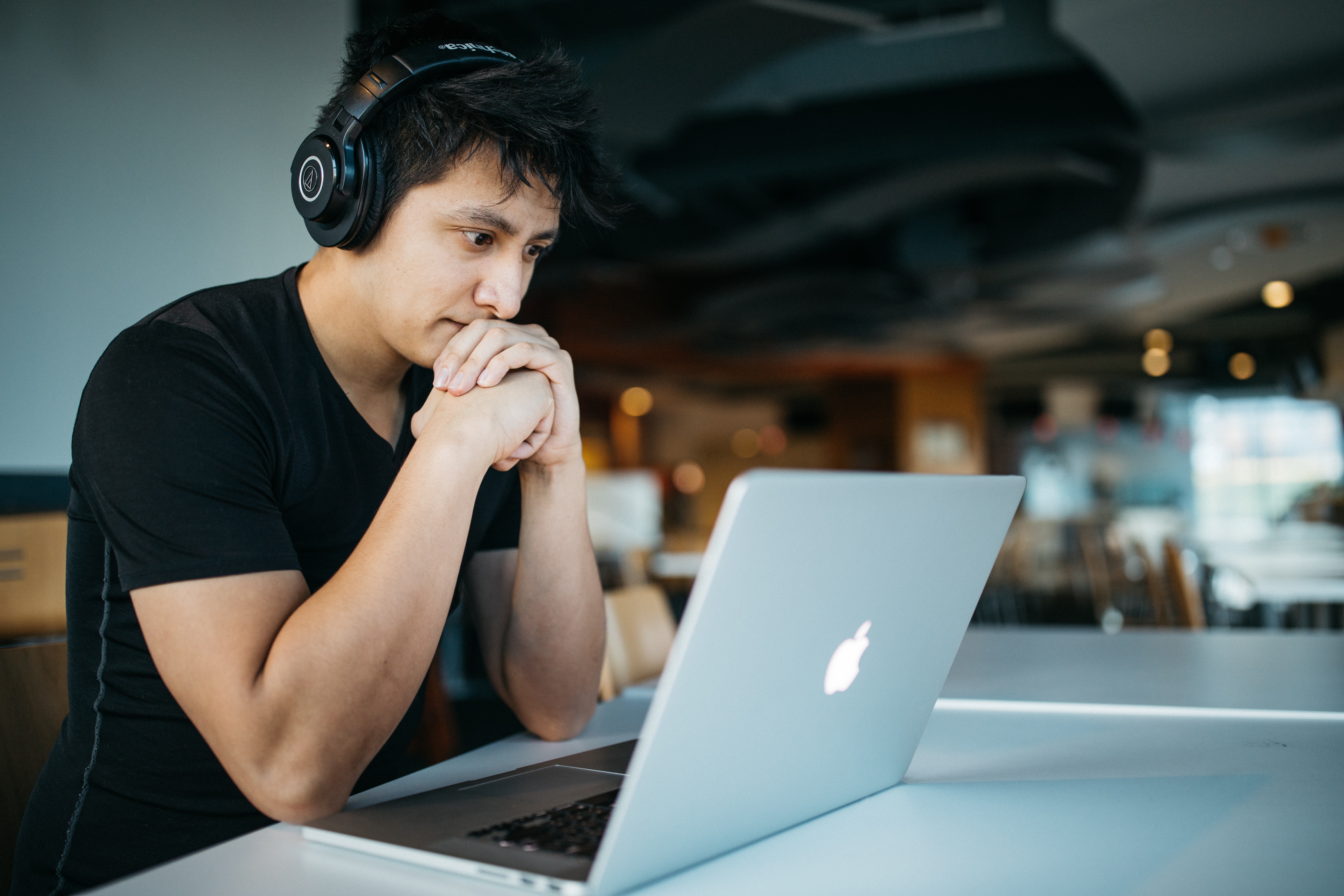 a man with headphones on a laptop