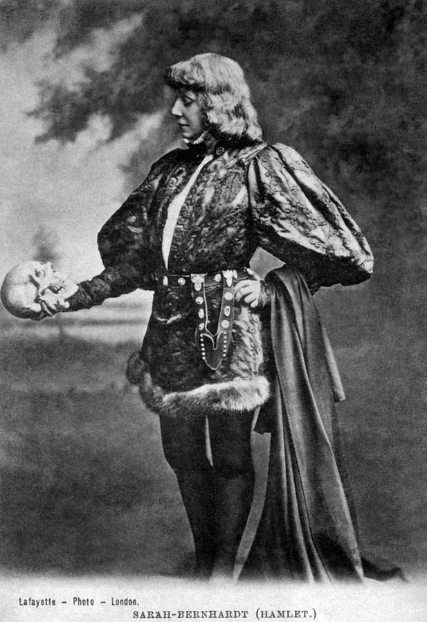 black and white photo of a woman holding a skull, portraying Hamlet