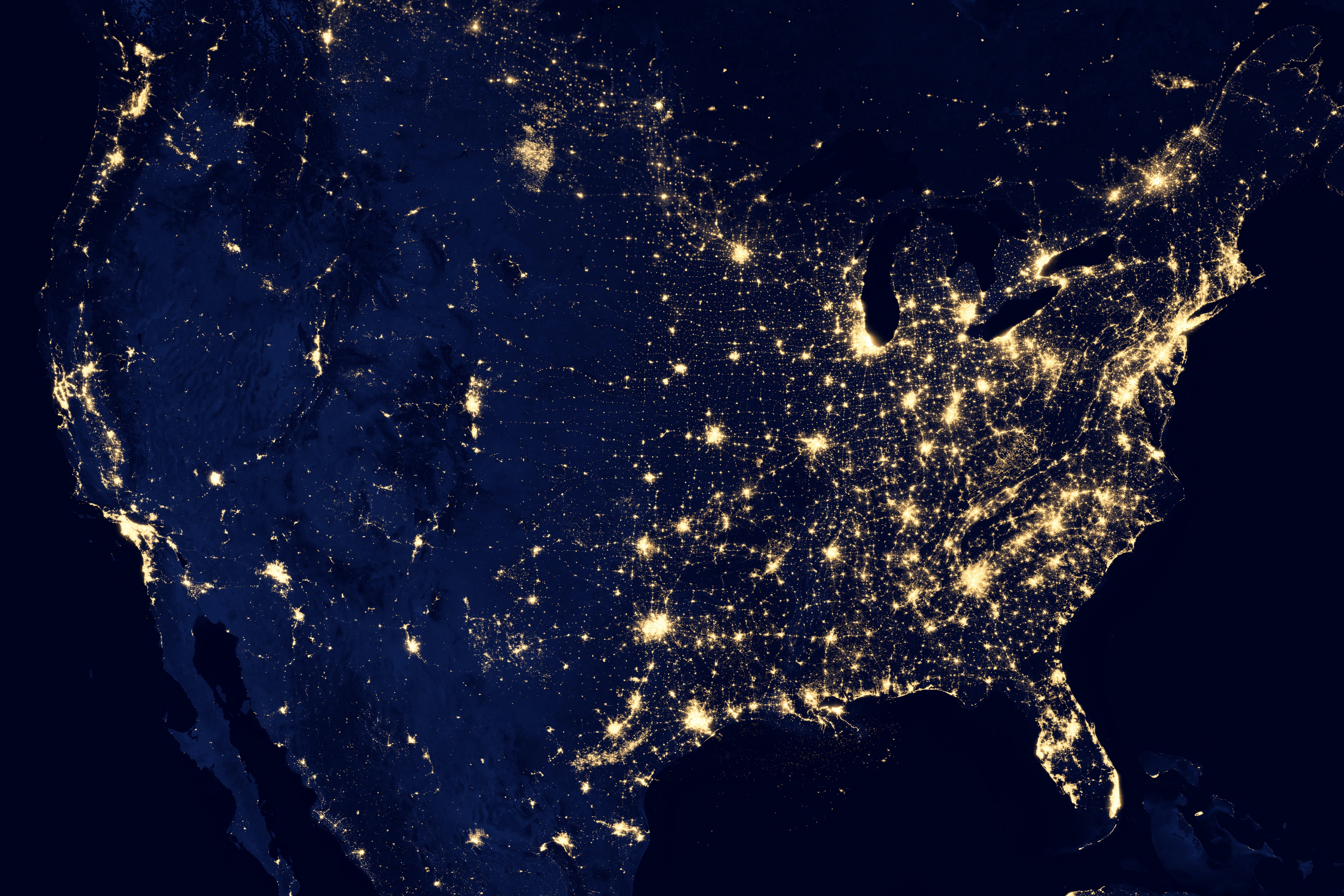 Photo of the united states in the dark with lights showing heavy populated areas