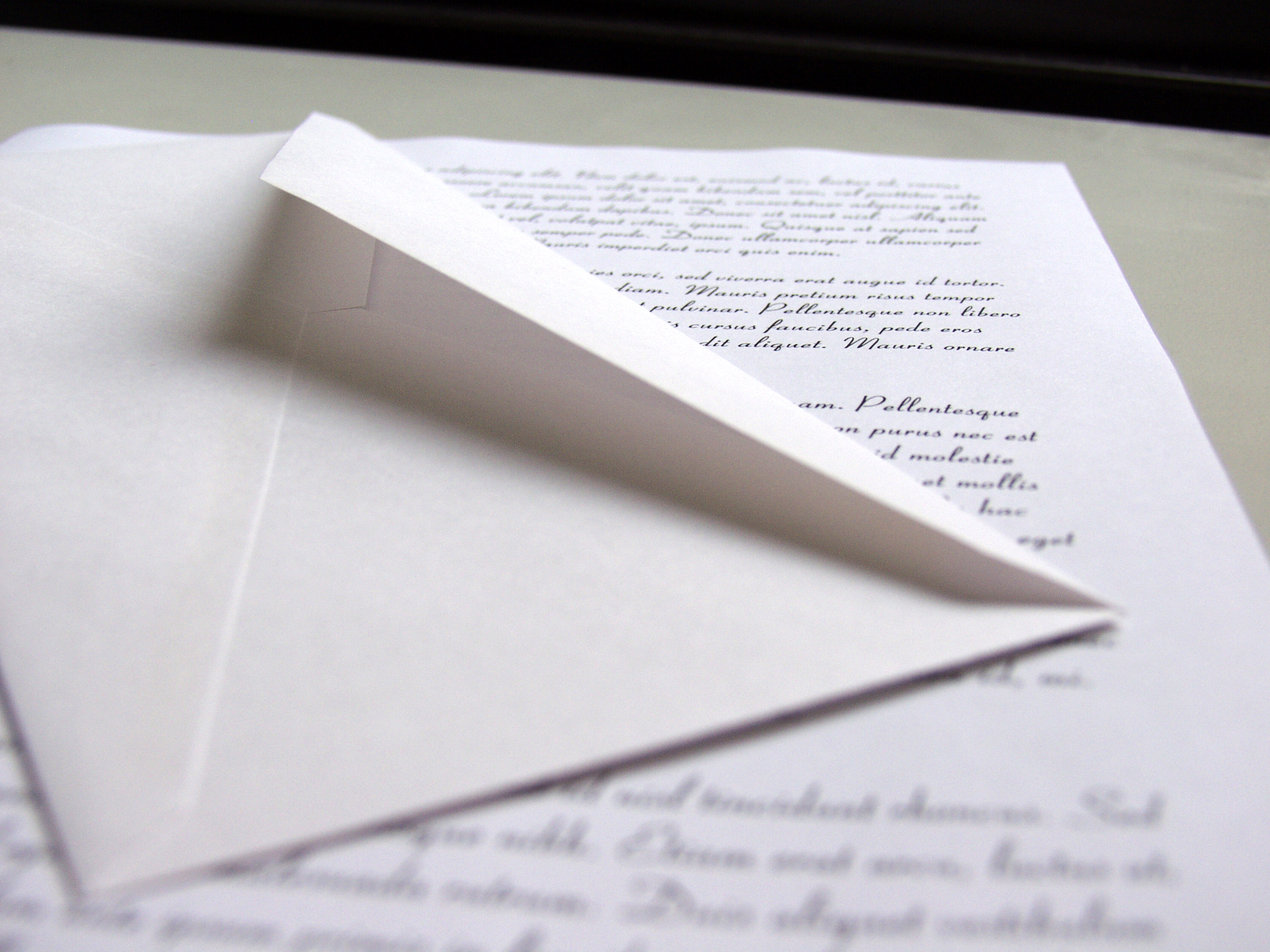 An open envelope sitting on top of a letter