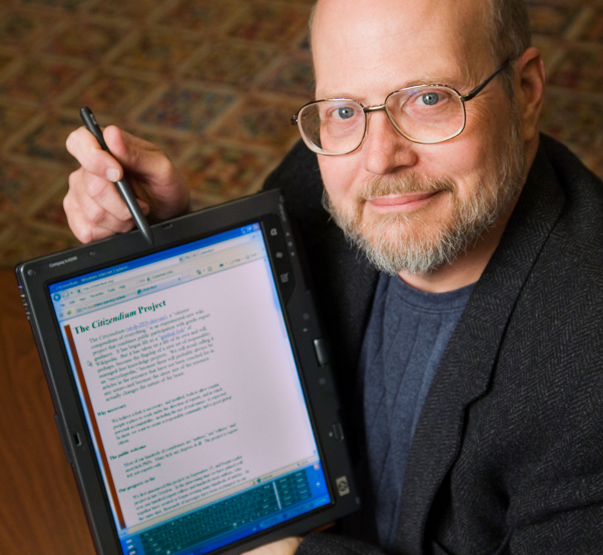 Photo of Ray Schroeder pointing to an iPad