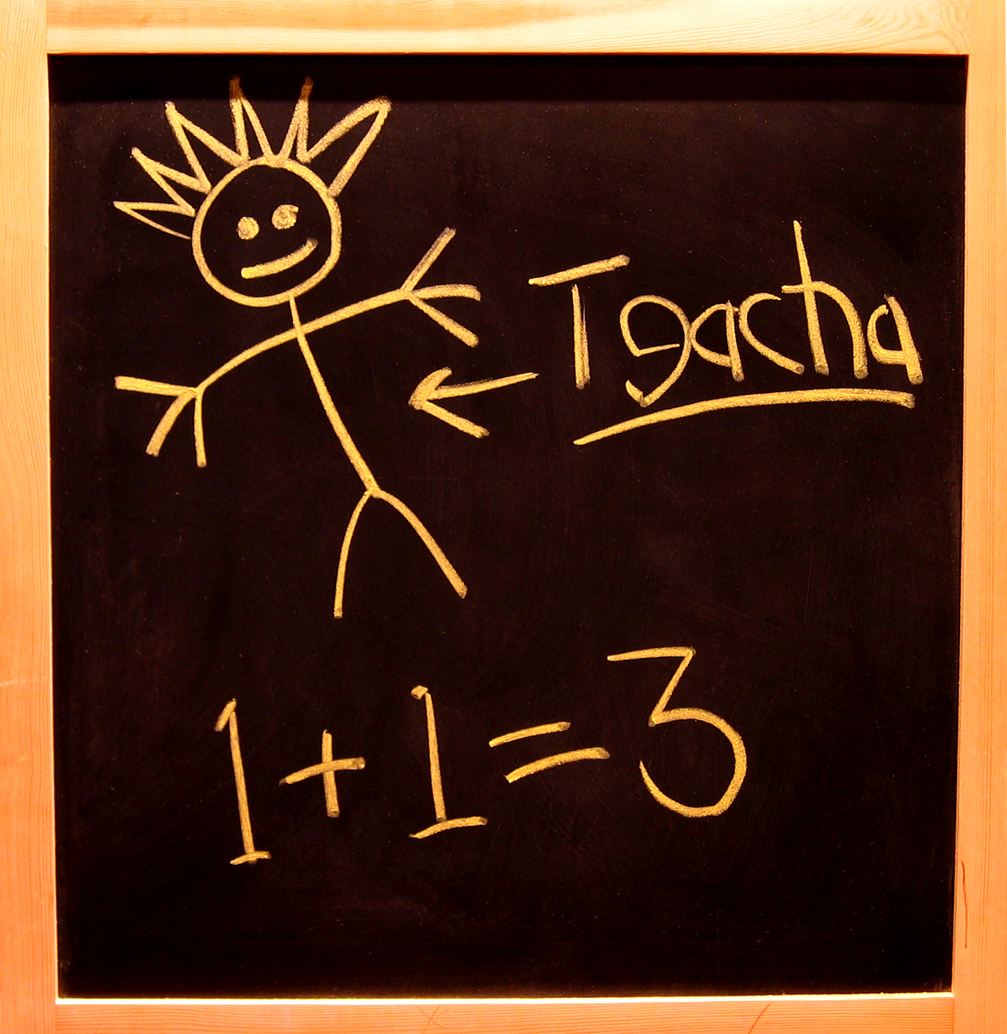 Blackboard with childish scrawl reading 1+1=3