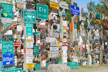 Wall of signs from many cities