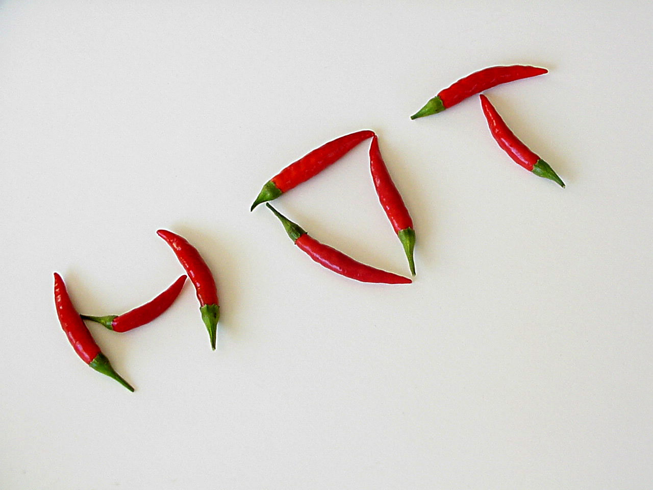 Photo of jalapeno peepers arranged to spell the word "hot"