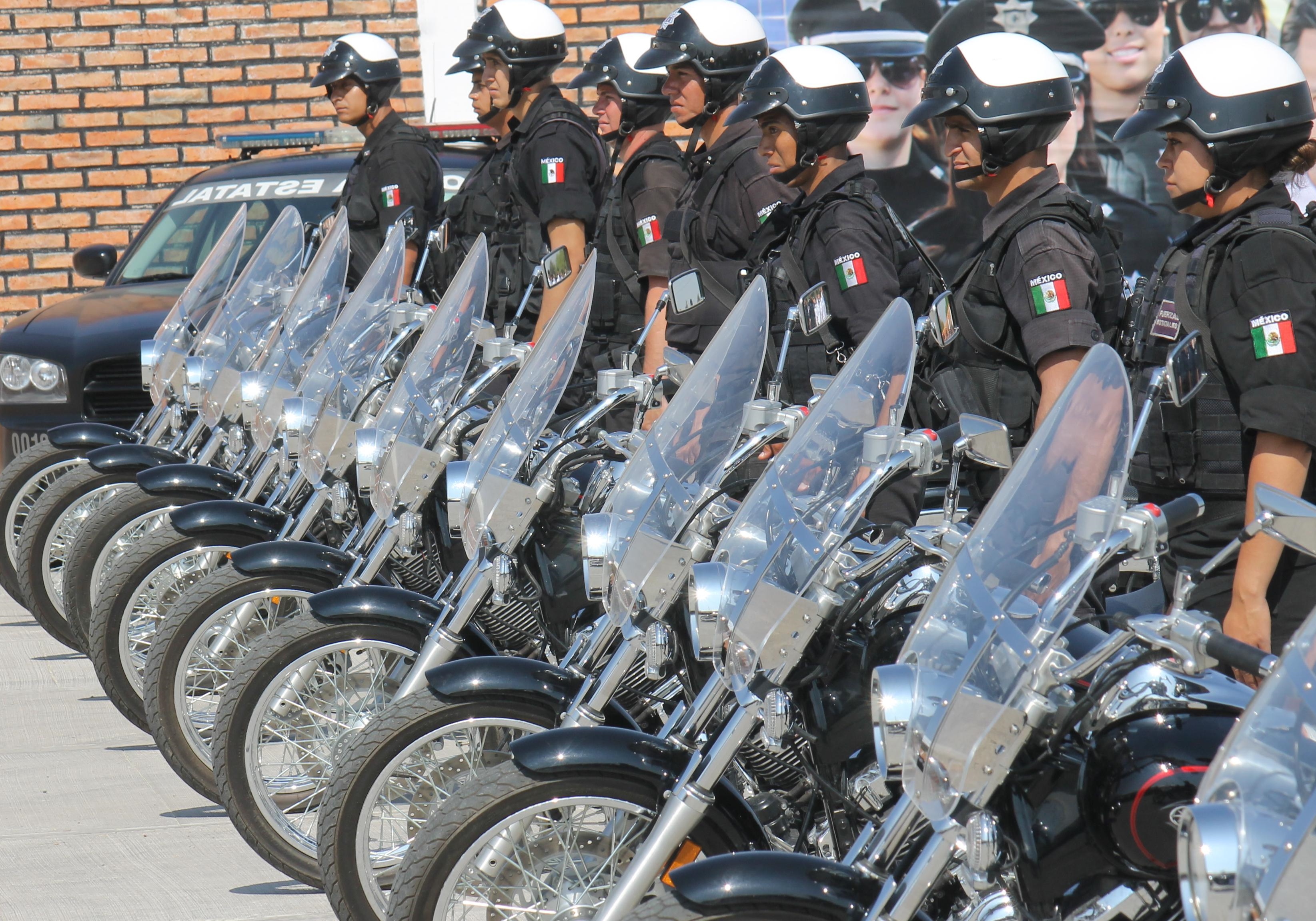 Photo of a line-up of  motorcycle police and their motorcycles.