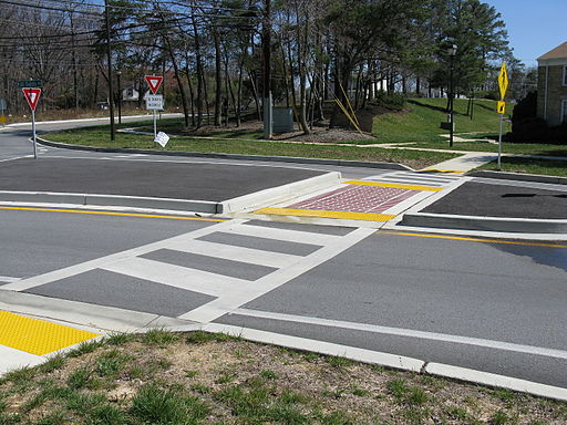 Photo of a curb cut on the side of a road and through a median.