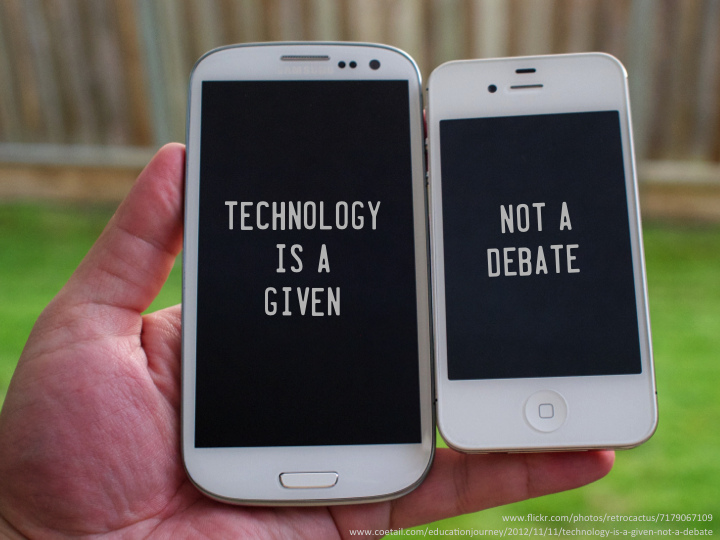 Hand holding two cell phones. The screen on the first phone reads "Technology is a given." The second phone reads "not a debate."