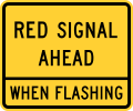 Warning sign that reads: "Red Signal Ahead When Flashing"
