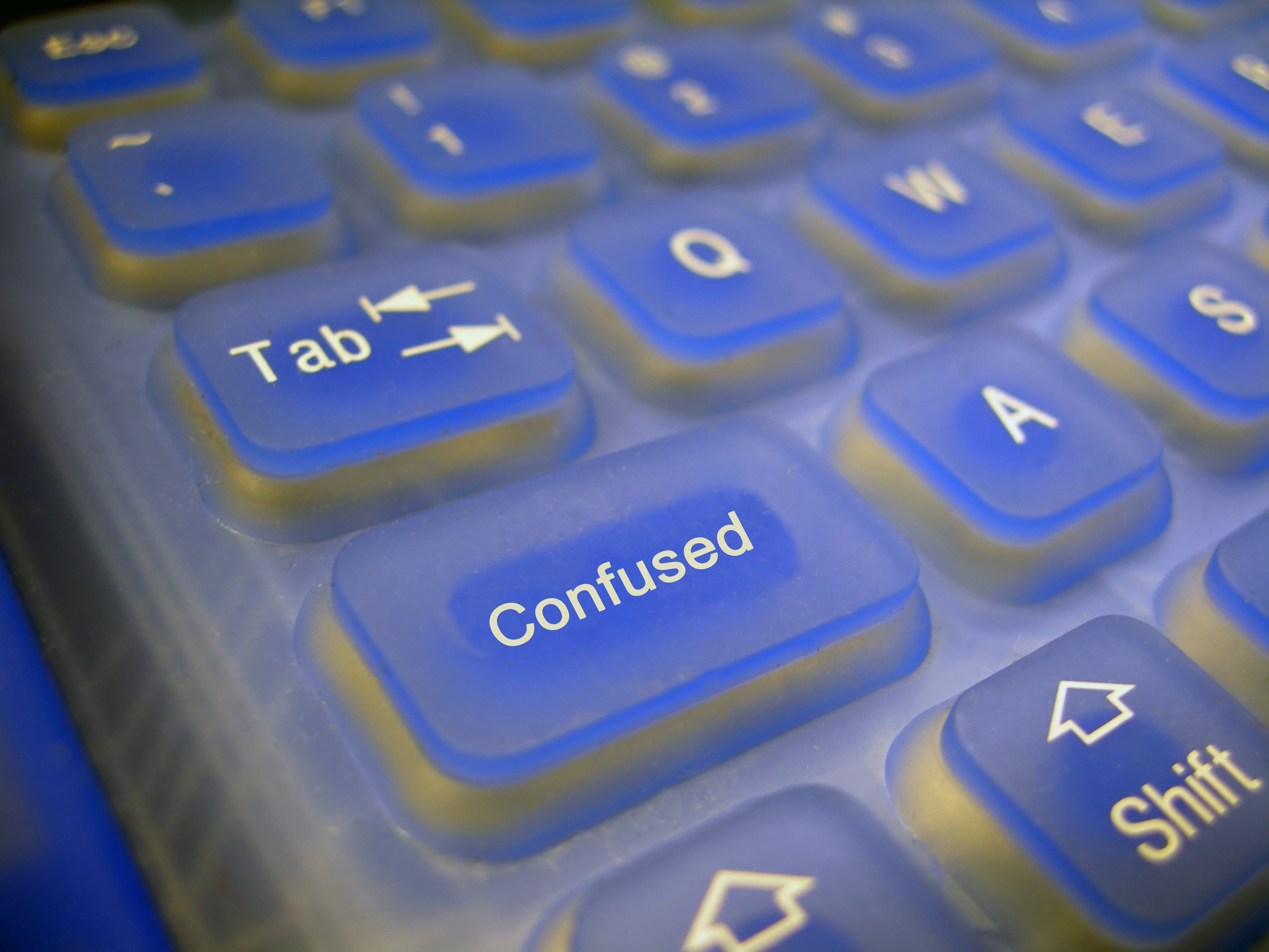 Computer keyboard with the key under the "tab" key labeled as "confused."