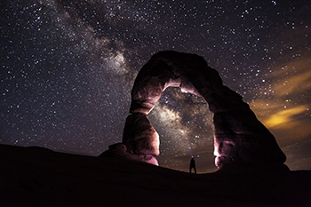 arch rock, climber and stars