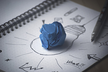 handdrawn light bulb with blue paper in middle depicting leadership