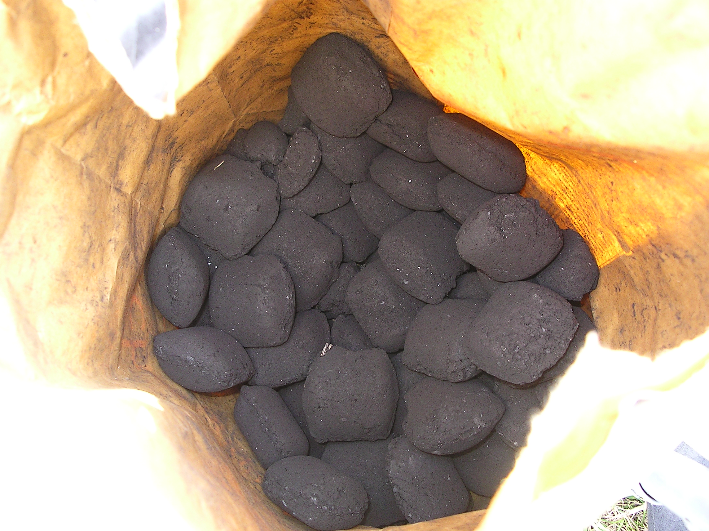 A container with several (maybe 47) lumps of coal in it.