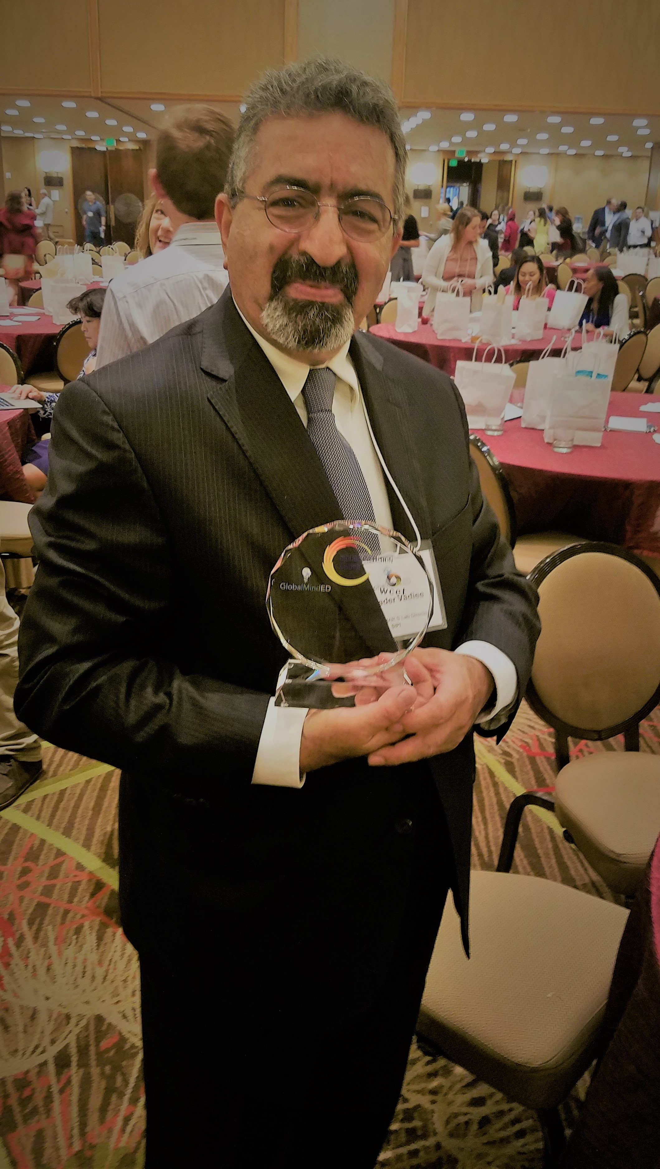 Dr. Vadiee holding Digital Inclusion Award