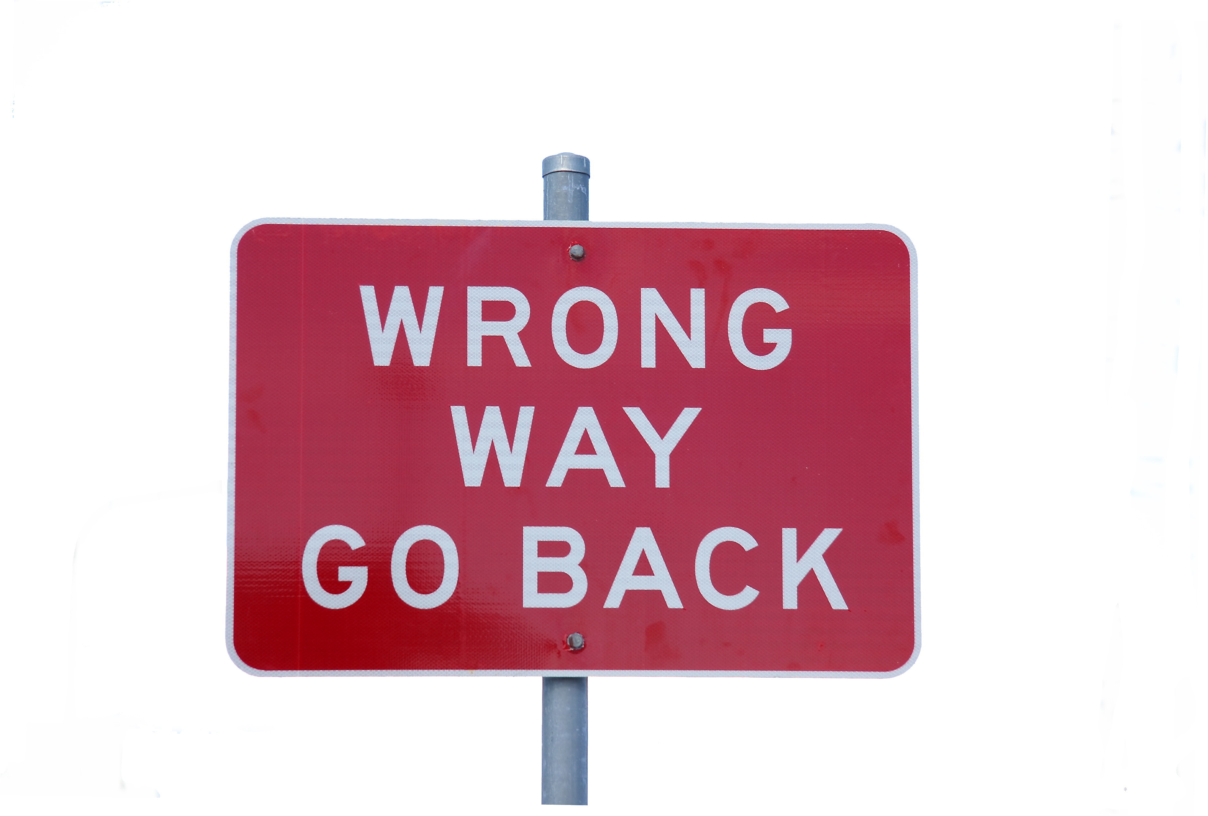 Street sign reading "Wrong Way Go Back".