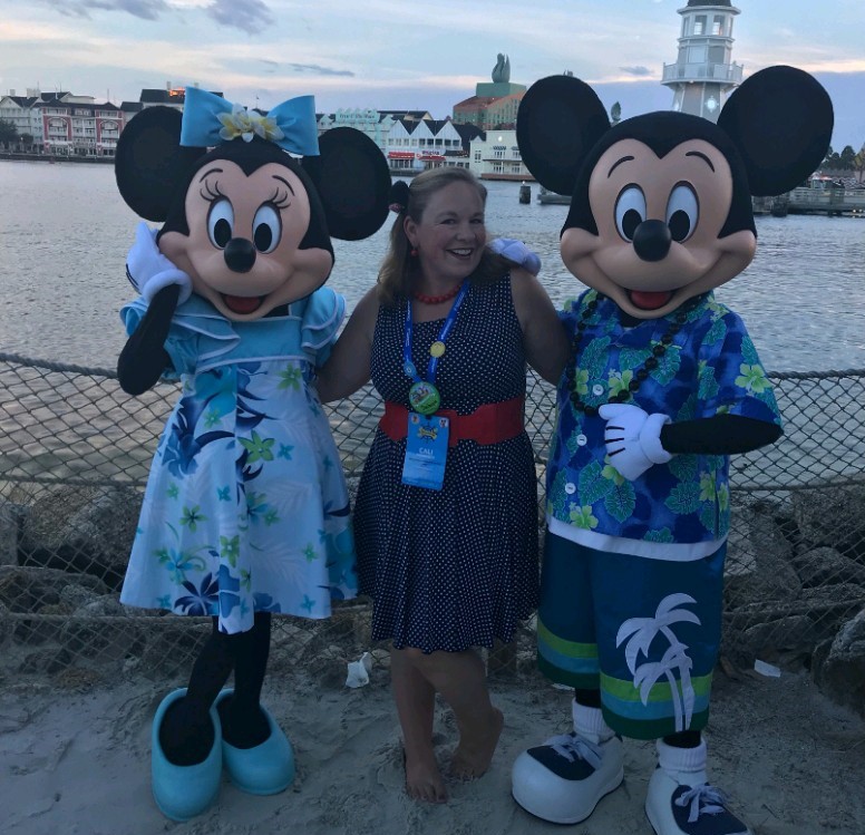 Cali poses with Mickey and Minnie