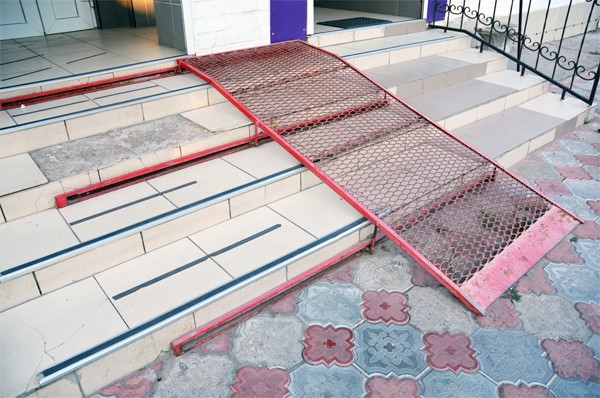 A wheelchair ramp over several stairs.