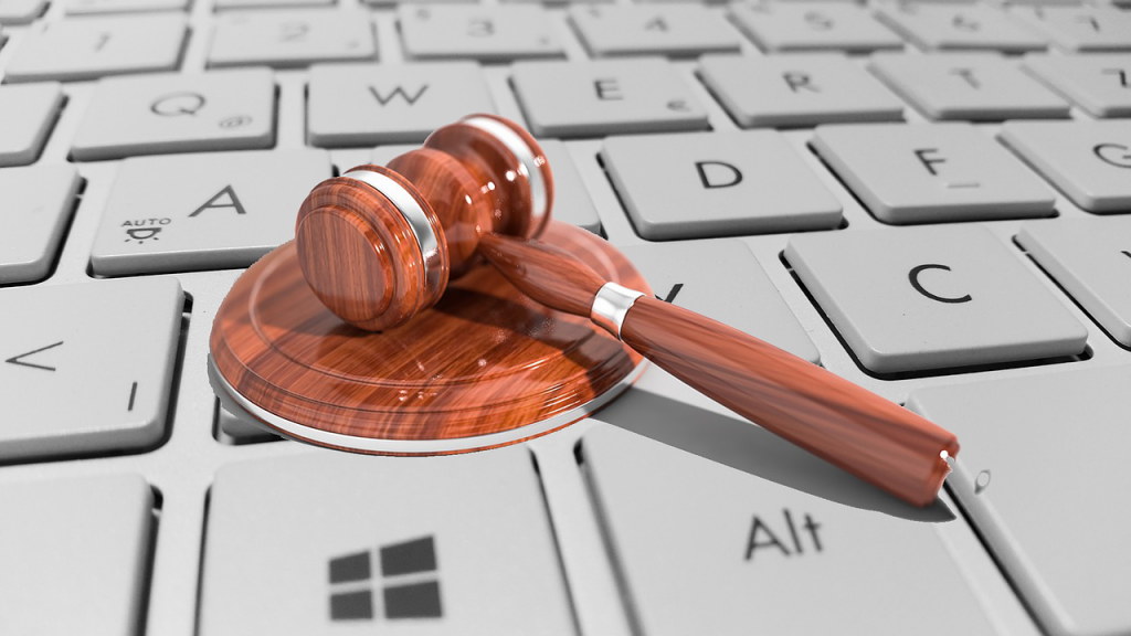 A photo of a gavel on a keyboard representing a legal finding in a technology-based case.