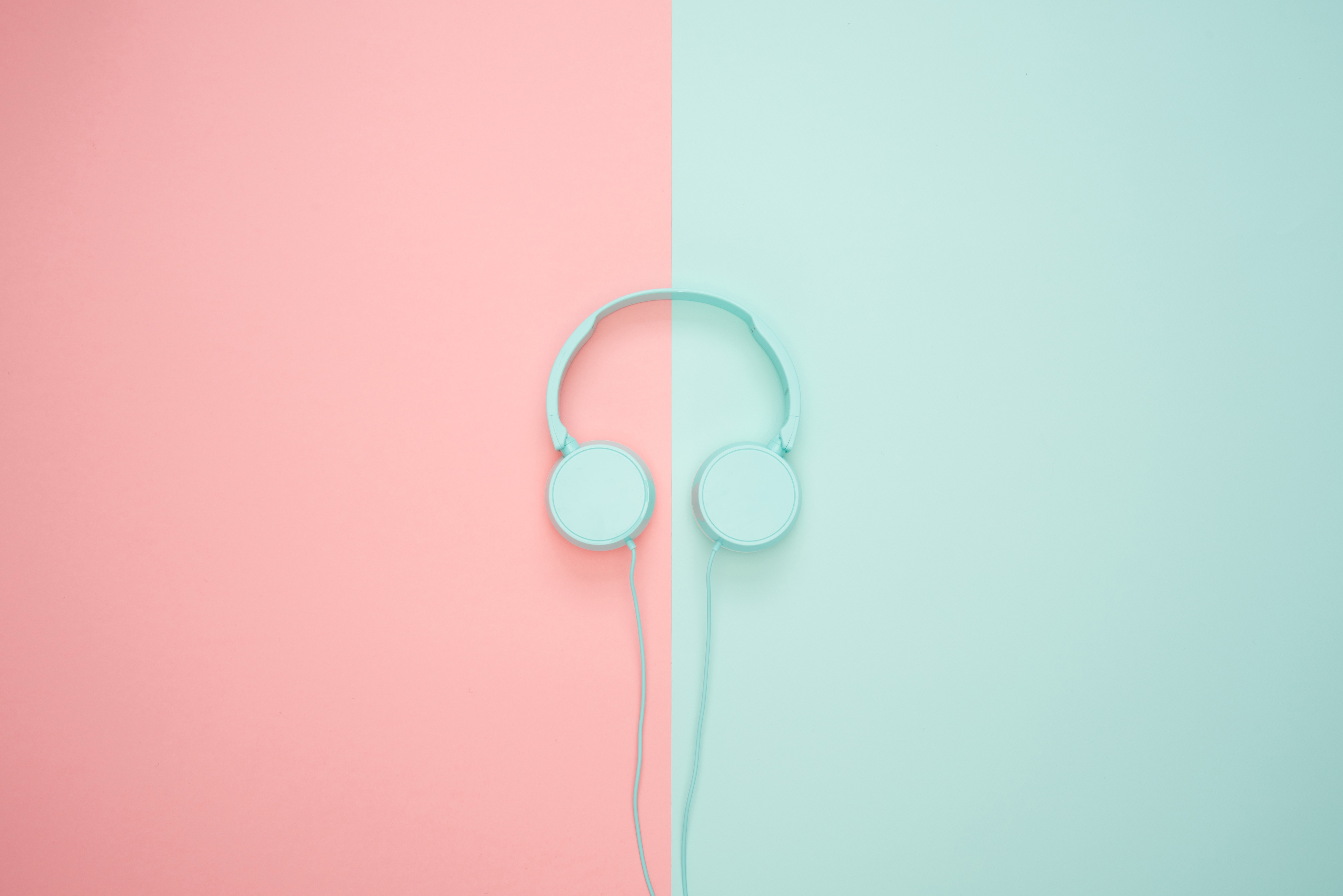 image of headphones on a pink and green background