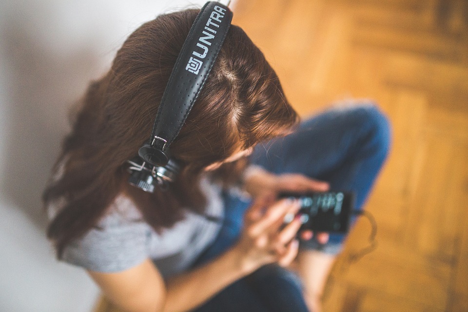 a woman listening to somthing with headphones