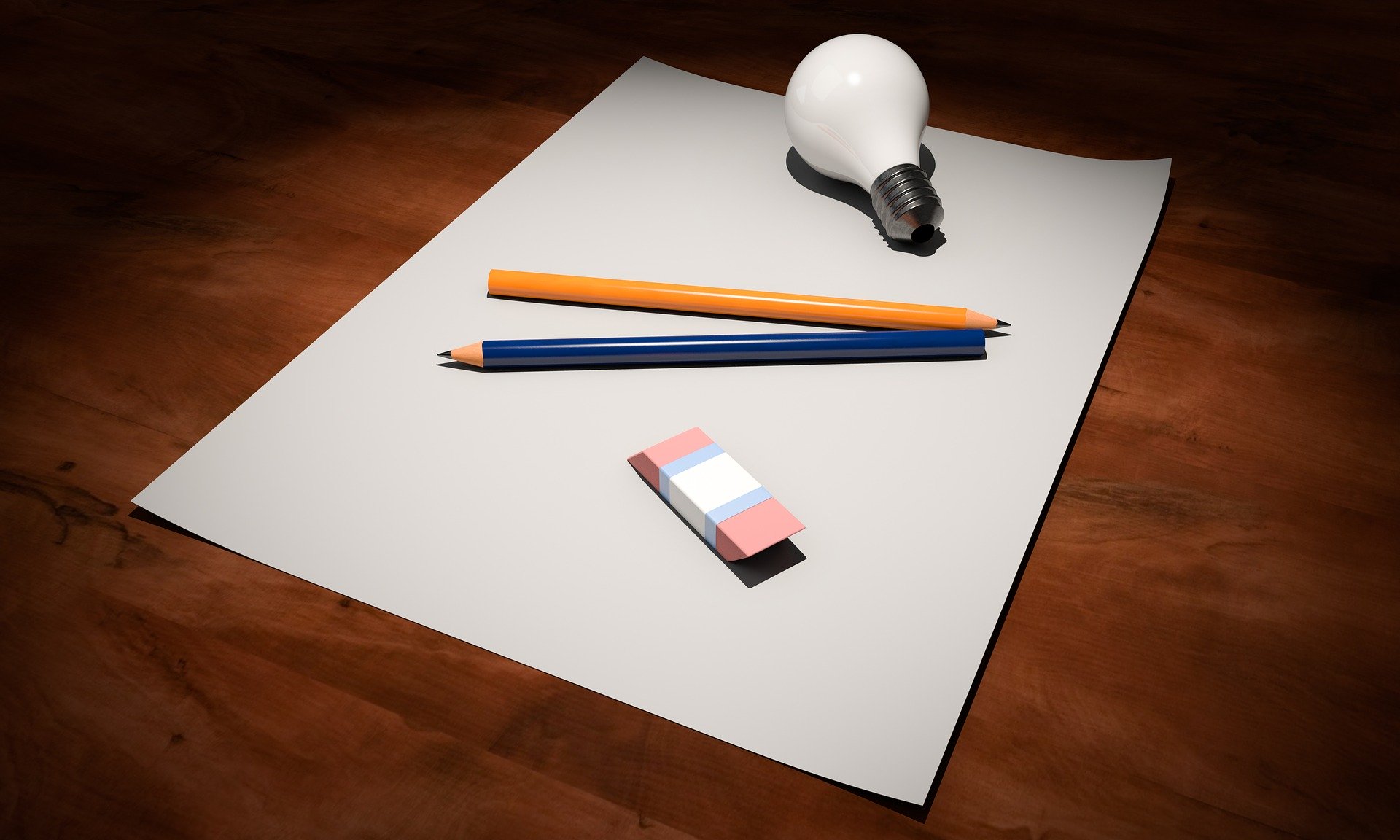 A piece of paper with pencils, eraser, and lightbulb