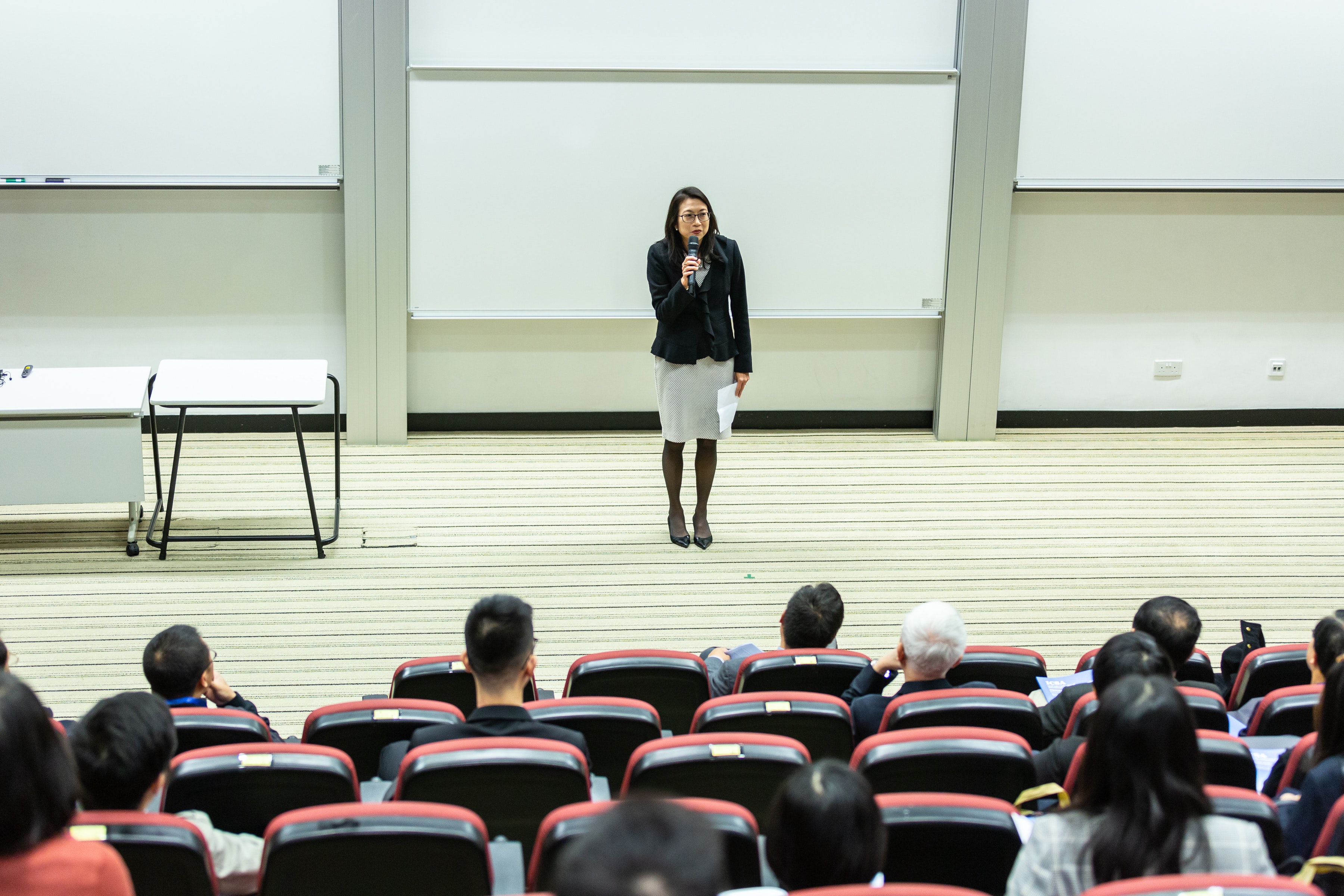 A woman lecturing to a large class