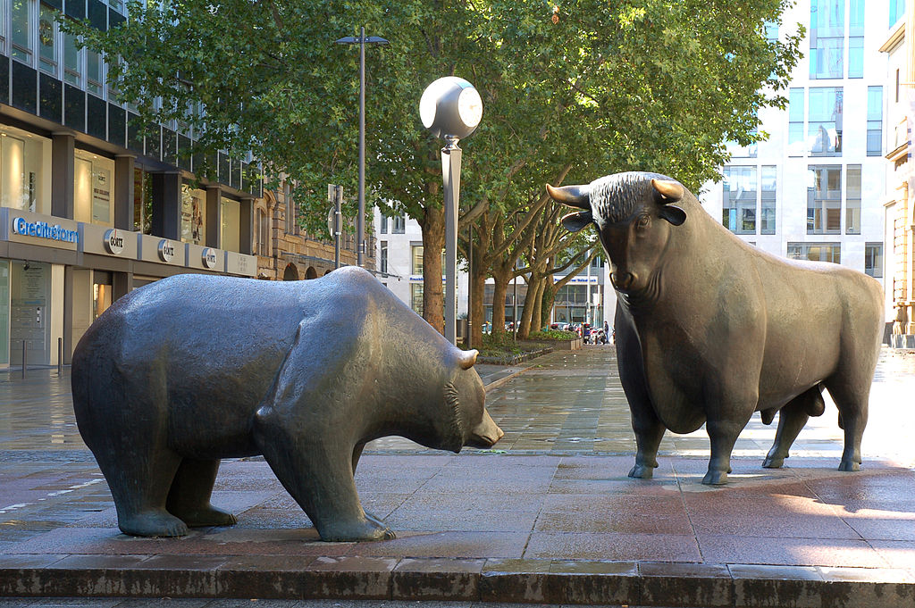 metal statures of a bull and a bear in a courtyard