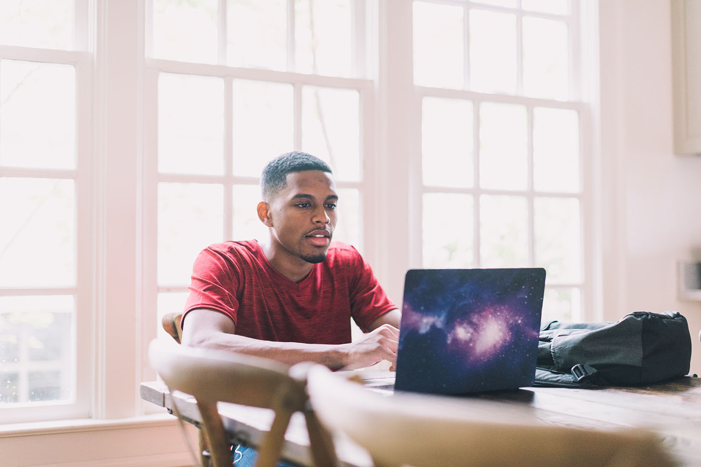 man focused on using a laptop