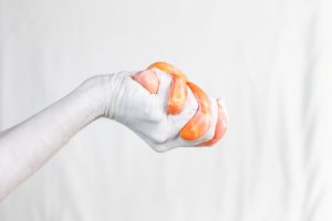 a hand holding orange slime