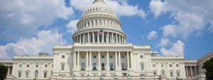 Image of the U.S. Capitol building with blue skies and fluffy white clouds