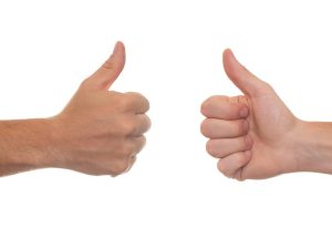 two hands with thumbs up
