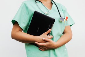 a nurse holding a tablet