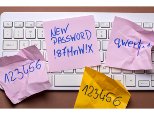 photo of several colorful sticky notes with passwords written on them laying on a keyboard
