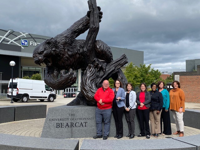 The State Authorization Working Group from UC with several members of the SAN team, posing in front of the UC Bearcat mascot statue