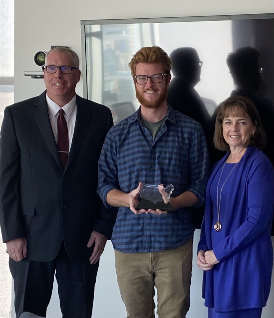 Photo of UT team members with award plaque and Cheryl Dowd, SAN