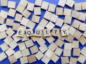 Scabble tiles spelling out "equity"