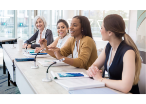 group of professional women speaking at a panel setup session