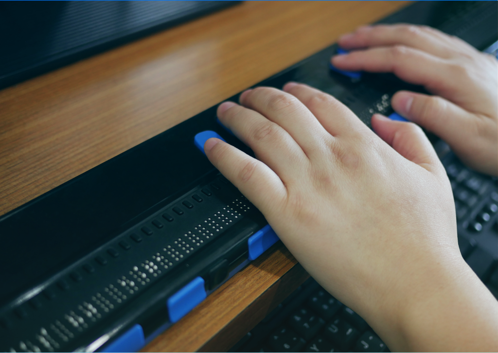 Someone using a braille terminal or braille display, an assistive technology to help individuals who need visual assistance to use a computer