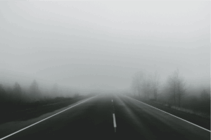 A road leading to a large fog bank