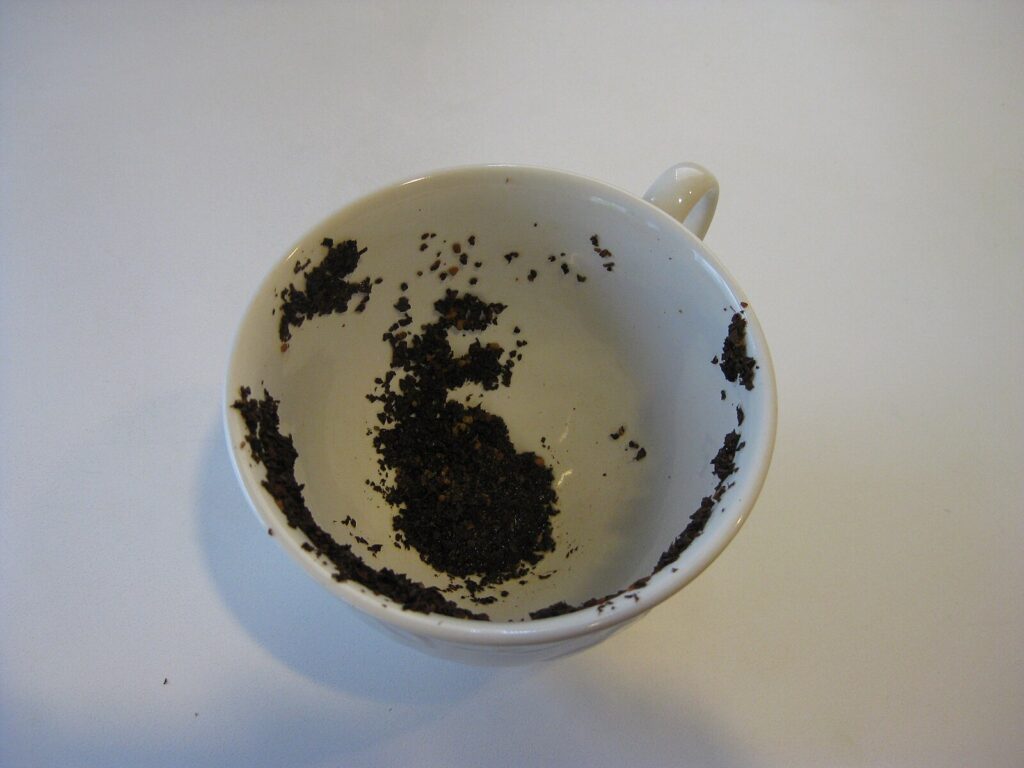 teacup showing tea leaves