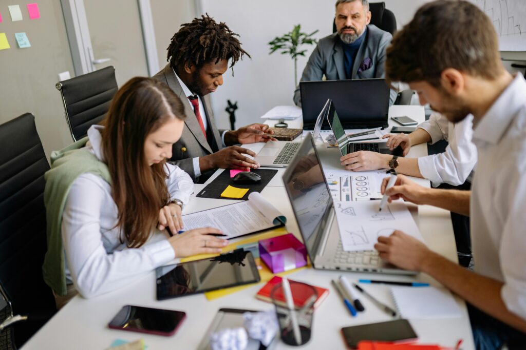 a team of marketing professionals reviewing colorful documents