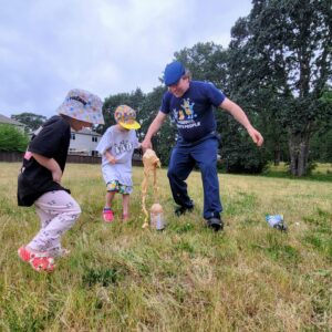 WSU Global Campus Cougs and Cubs family outdoors doing a science experiment with soda