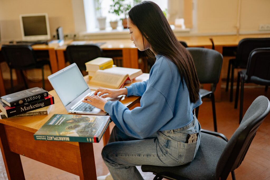 Woman studying on a laptop at a desk