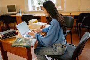 Woman studying on a laptop at a desk