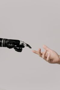 AI represented by a robot hand reaching out to a human hand