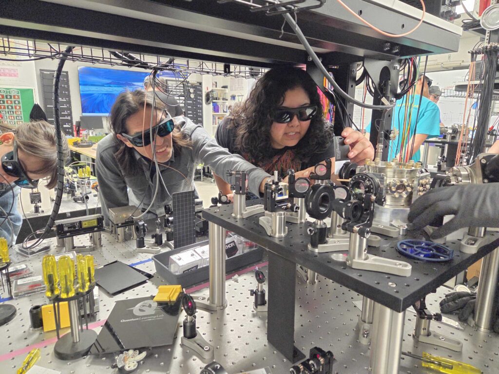 Two students working with equipment in the CNM Ingenuity lab for Quantum Boot Camp