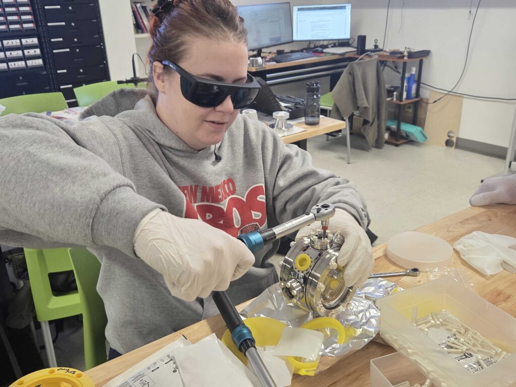 Female student working with equipment in the CNM Ingenuity lab for Quantum Boot Camp