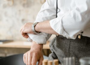 Close-up image of person rolling up their shirt sleeves
